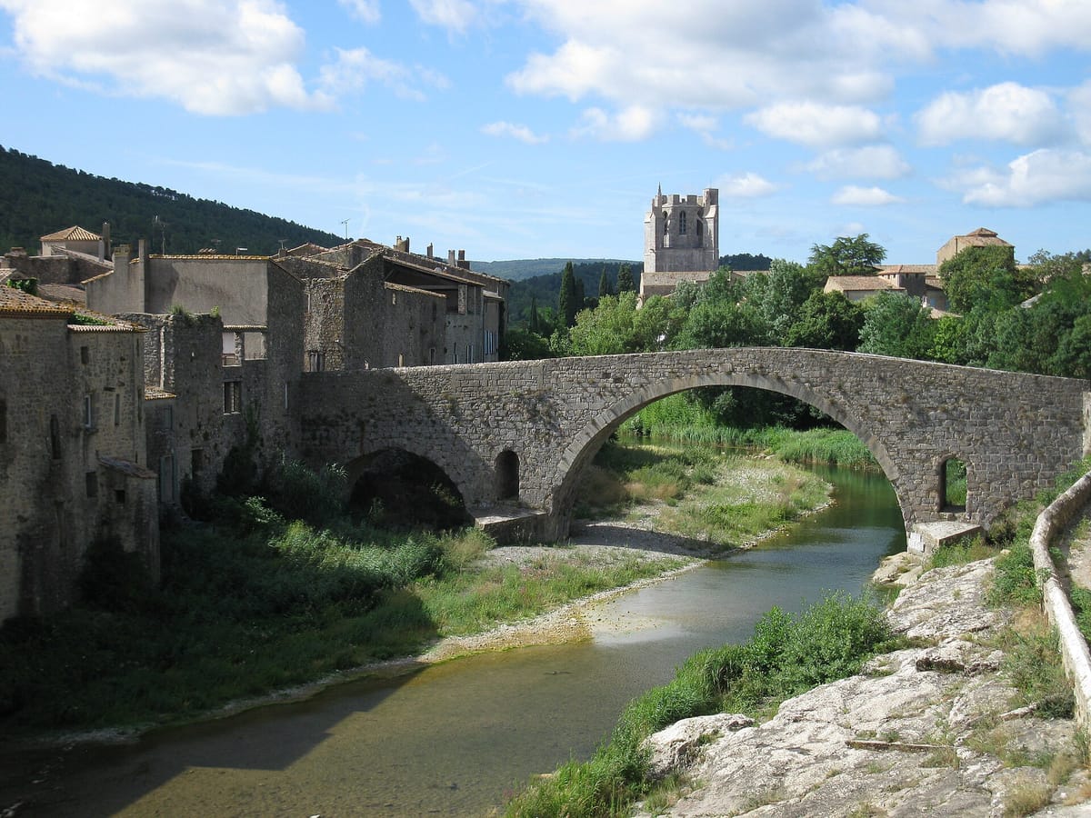 Le pont de pierre de Lagrasse sur l’Orbieu, avec le clocher de l’abbaye